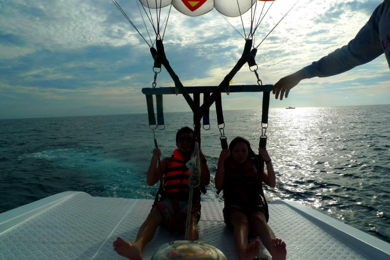 Evan and Raevian landing on boat after parasailing