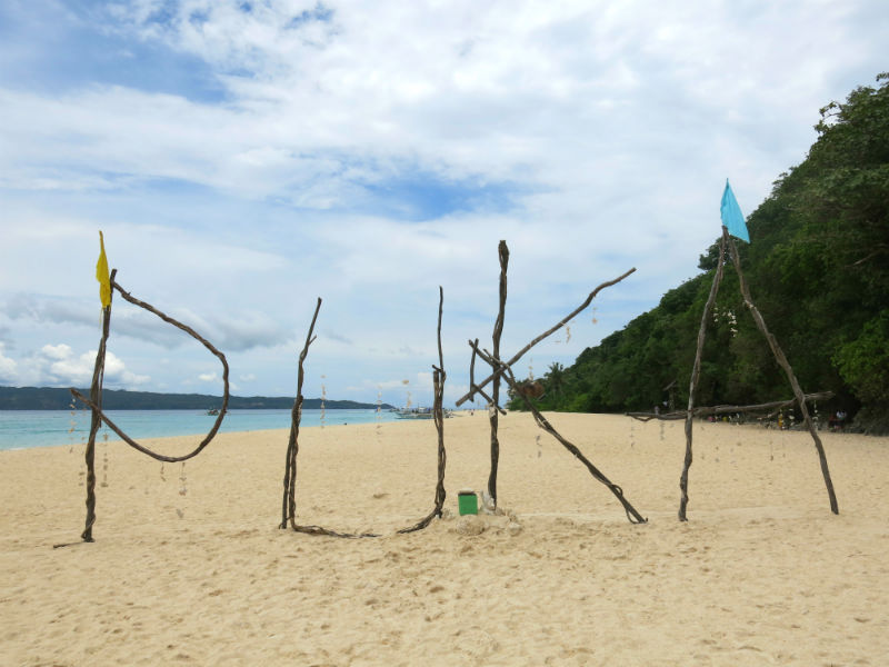 Puka Beach sign built using wood