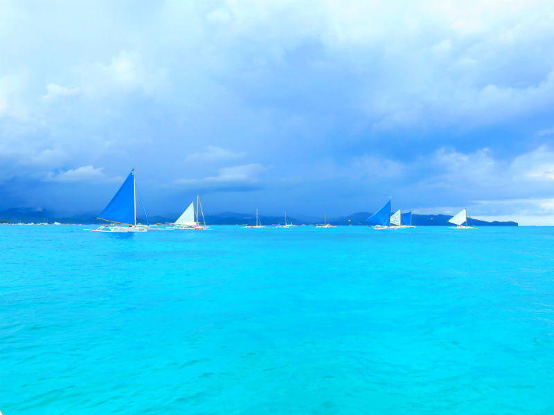 Turquoise sea with paraws in distance