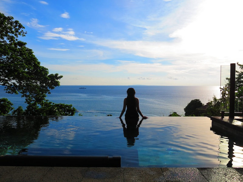 Silhouette of Raevian sitting on edge of Infinity Pool 