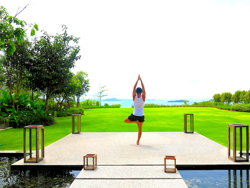 Evan doing yoga pose with beautiful sea view