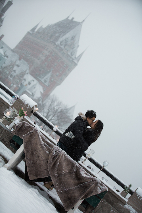 Kissing in front of Fairmont Le Chateau Frontenac