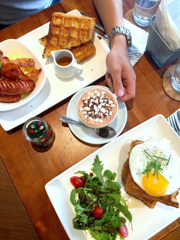 Monniker Brunch Spread with Hand holding Hot Chocolate